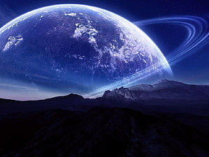 Giant Ringed Planet Rising Over a Dark Mountainous Landscape in Deep Space HD wallpaper