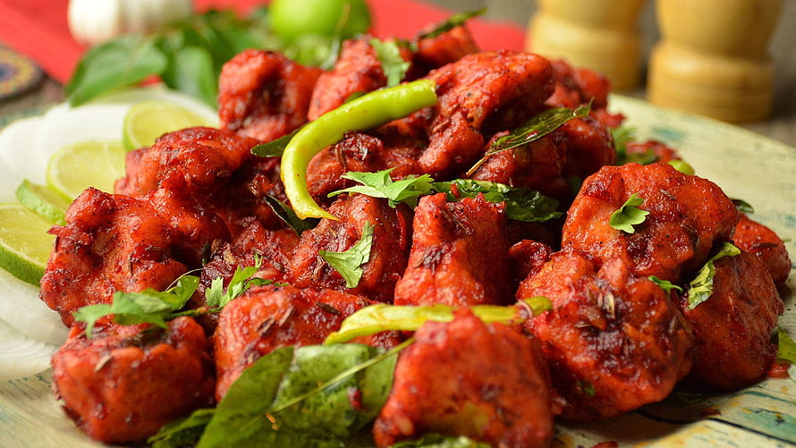 Spicy Chicken 65 with Fresh Green Chilies and Curry Leaves on a Rustic Plate HD wallpaper