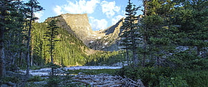 Majestic Mountain Valley with Pine Forest and River Under Blue Sky HD wallpaper