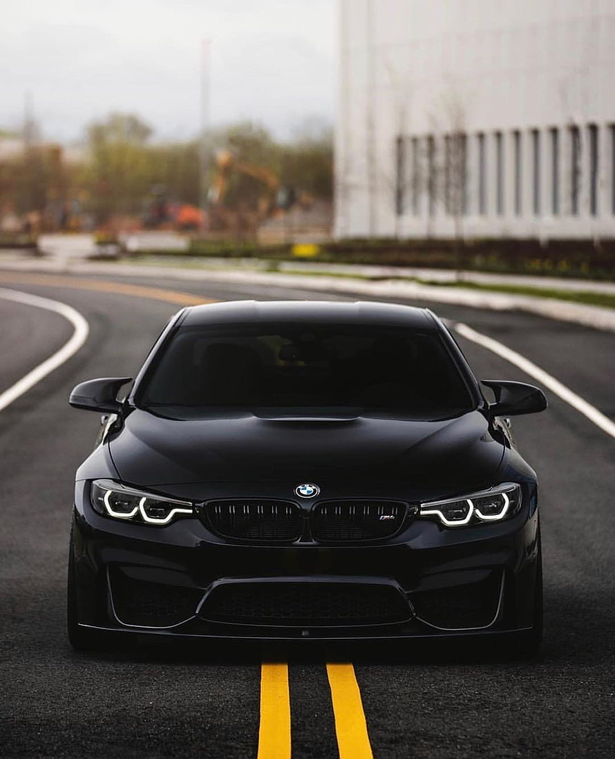 Black BMW M4 Competition Package Front View on Curved Road HD phone wallpaper