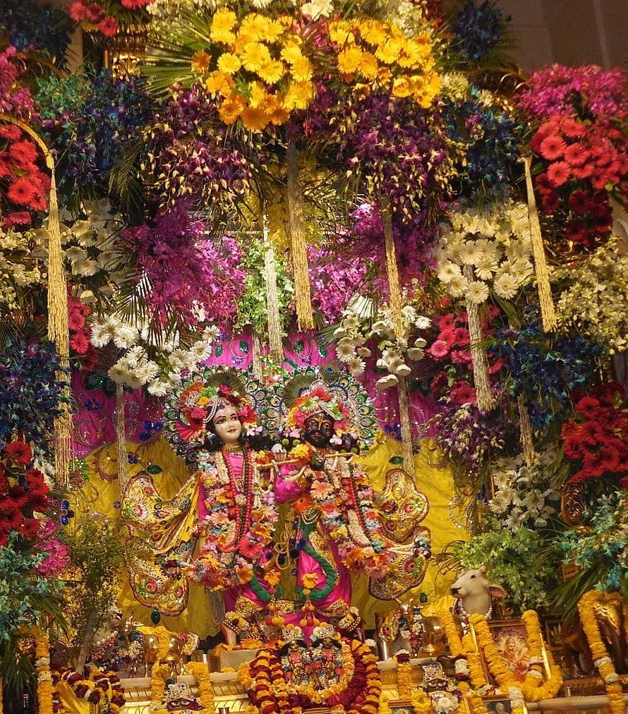 Ornate Hindu Deity Statues Adorned with Vibrant Floral Garlands in Vrindavan Temple HD phone wallpaper