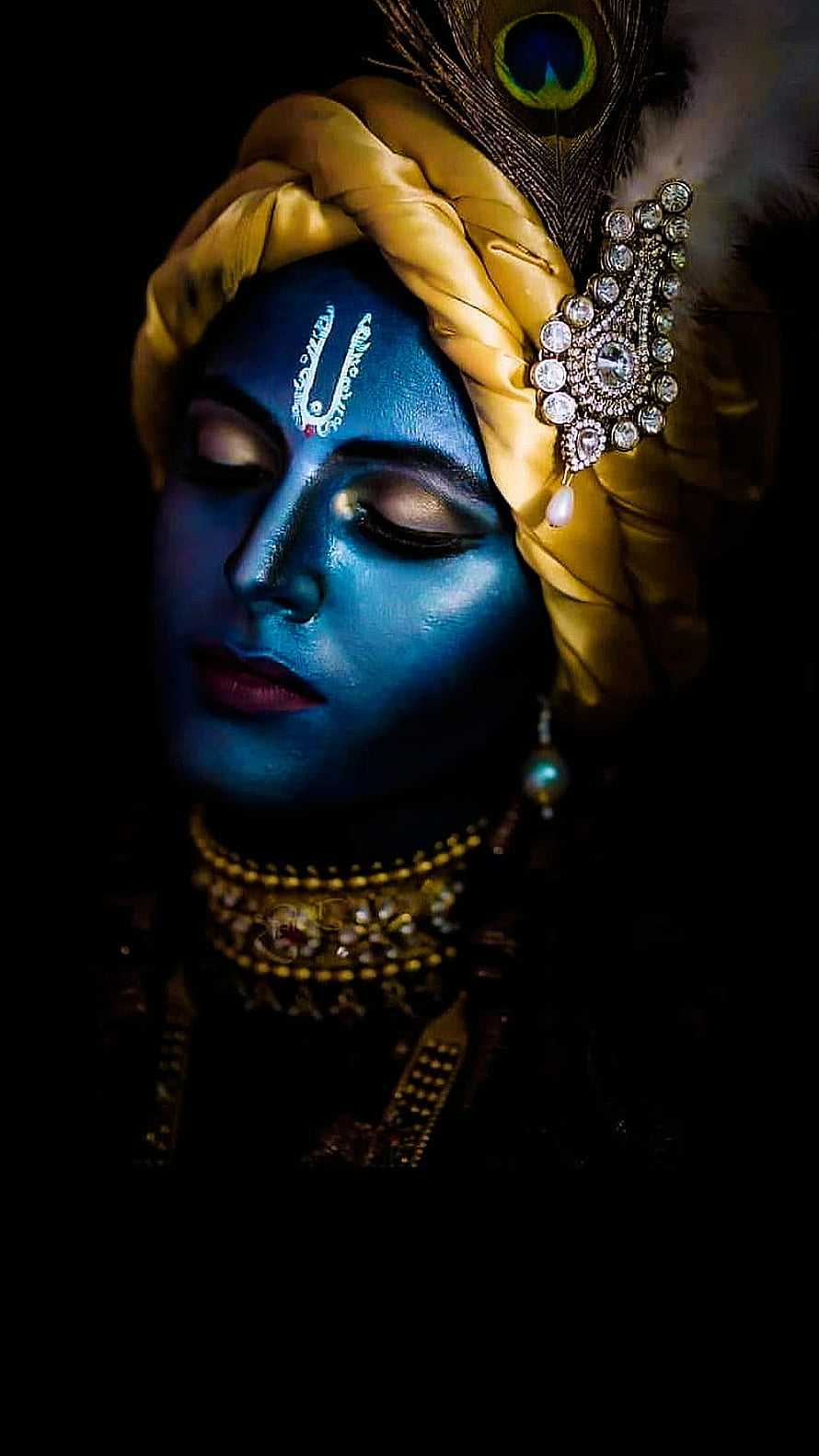 Krishna Portrait with Blue Face Paint, Golden Turban, Peacock Feather, and Ornate Jewelry HD phone wallpaper
