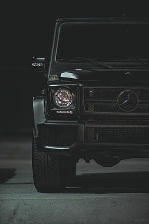 Black Mercedes G-Class Front Grille and Headlight Detail in Low Light HD phone wallpaper