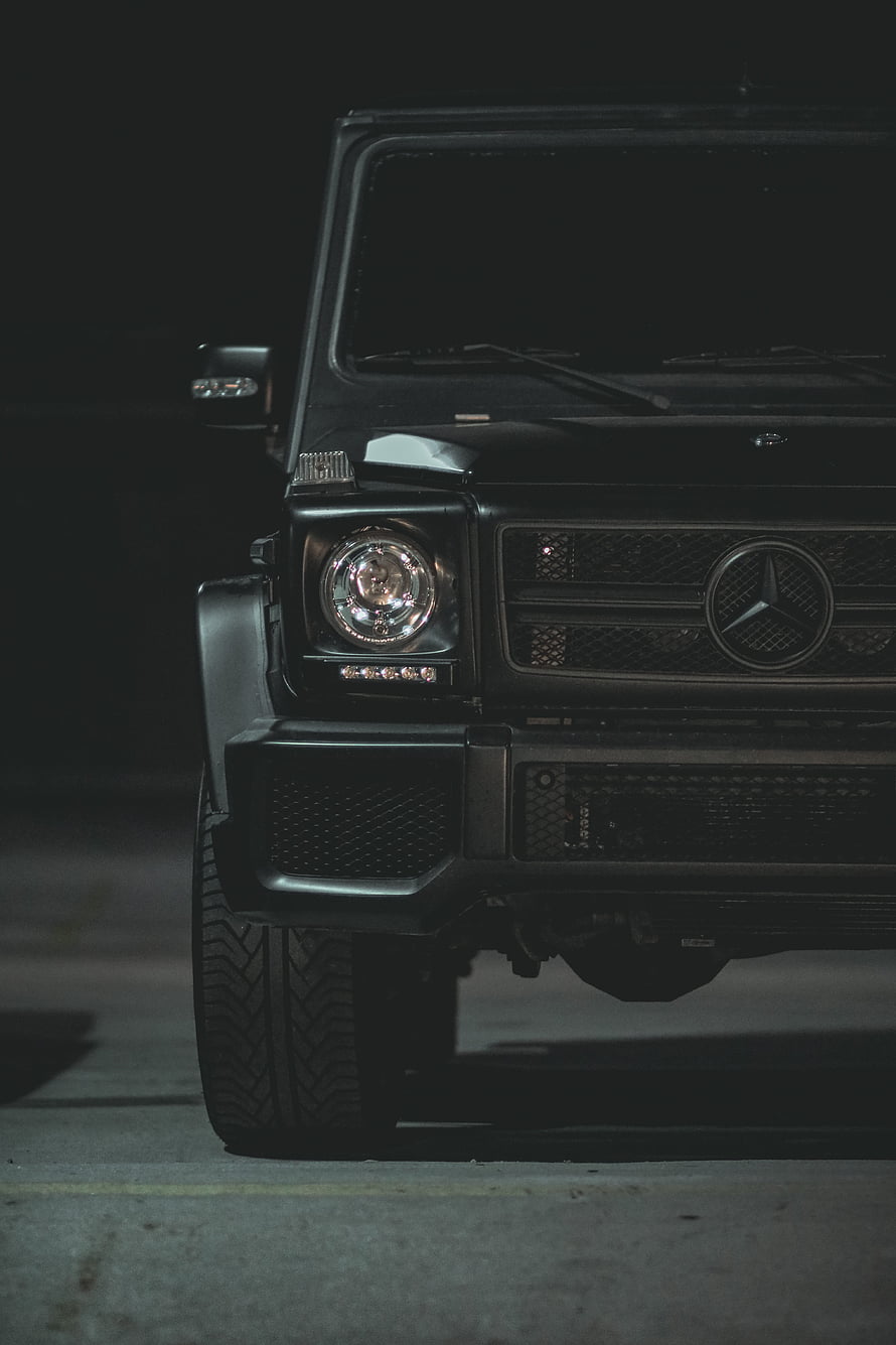 Black Mercedes G-Class Front Grille and Headlight Detail in Low Light HD phone wallpaper