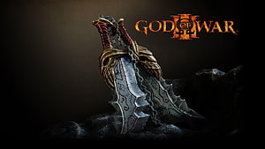 God of War Blades of Chaos resting on dark stone with ornate golden hilts and engraved silver blades HD wallpaper