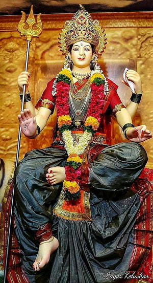 Maa Durga Murti with Trishul and Floral Garland in Traditional Attire HD phone wallpaper