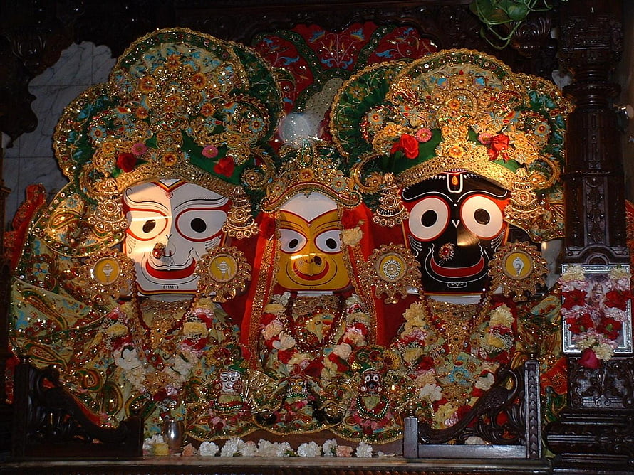 Ornate Jagannath Temple Deities with Elaborate Gold and Floral Decorations HD wallpaper