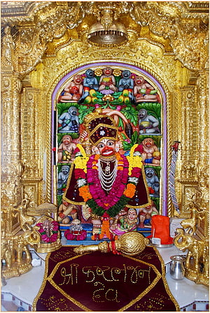 Kashtabhanjan Dev Hanumanji Temple Shrine with Golden Carved Arch and Floral Offerings HD phone wallpaper