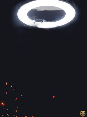 Minimalist Ring Light Studio Setup with Dramatic Dark Background and Red Sparks HD phone wallpaper