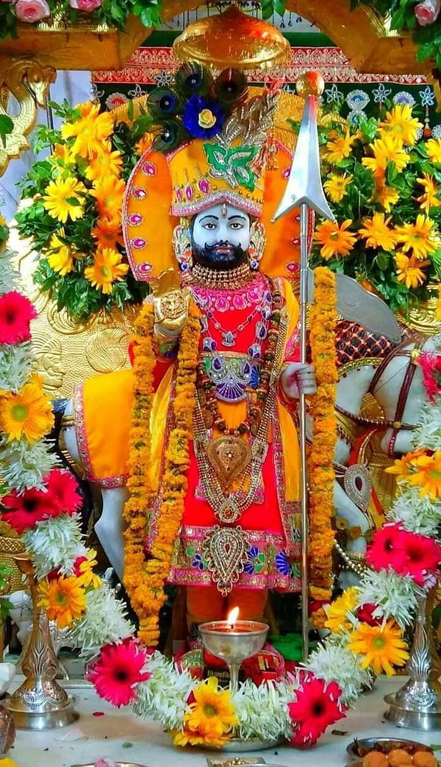 Ornate Ramdev Ji Murti Adorned With Marigold Garlands And Sacred Trishul HD phone wallpaper