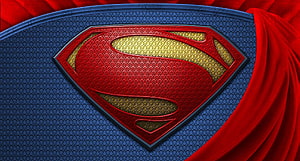 Superman S-Shield Emblem on Textured Blue Suit with Flowing Red Cape HD wallpaper