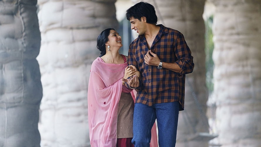 Romantic Indian couple sharing a tender moment in a stone archway HD wallpaper