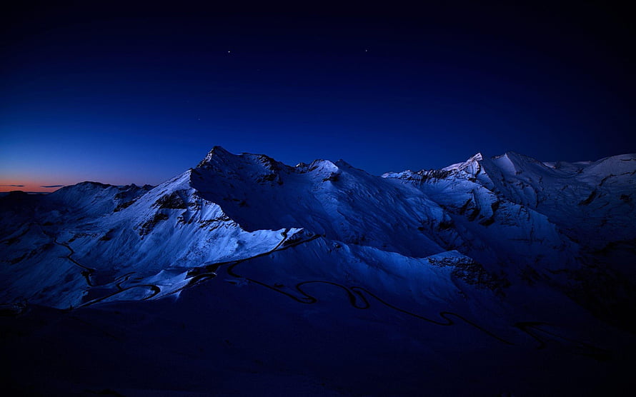 Snow-Capped Mountain Ranges Under a Deep Blue Twilight Sky HD wallpaper