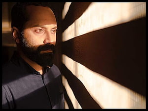 Fahadh Faasil in Dramatic Profile Portrait with Warm Window Light and Deep Shadows HD wallpaper