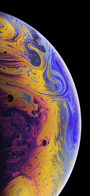 Vibrant Swirling Planet Surface with Purple and Gold Marbled Patterns Against Black Space HD phone wallpaper