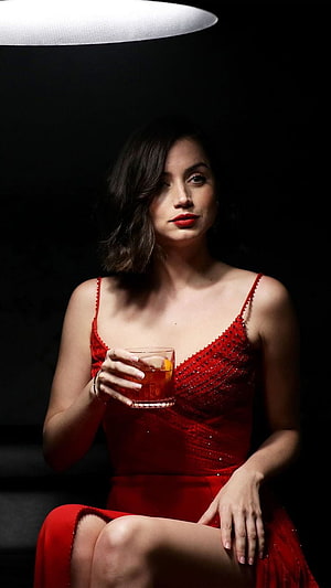 Ana de Armas in a red beaded dress holding a cocktail against a dark background HD phone wallpaper