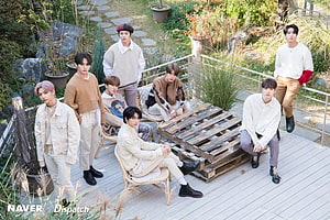 Stray Kids in Earth-Tone Knitwear on a Garden Deck HD wallpaper