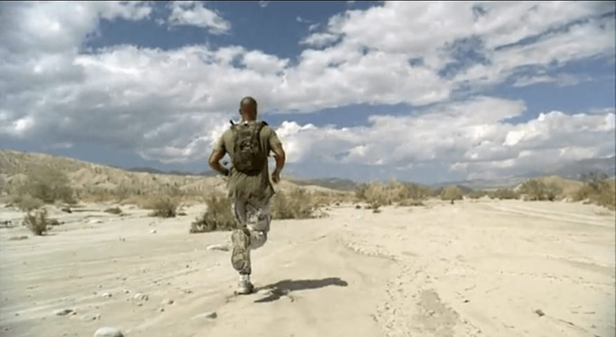 David Goggins Running Through Desert Landscape With Backpack Under Cloudy Sky HD wallpaper