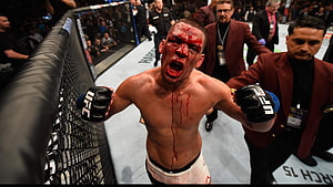 UFC Fighter Roaring in Victory Inside the Octagon Cage HD wallpaper