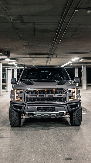 Front View of a Dark Grey Ford F-150 Raptor Pickup Truck Parked in an Underground Garage HD phone wallpaper