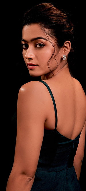 Rashmika Mandanna in a dark green velvet dress with an elegant updo and diamond earrings HD phone wallpaper