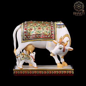 Kamadhenu Cow and Calf Decorative Statue with Ornate Floral Patterns and Gold Accents HD phone wallpaper