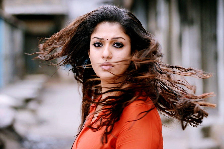 Nayanthara Portrait with Windblown Hair in Orange Top HD wallpaper