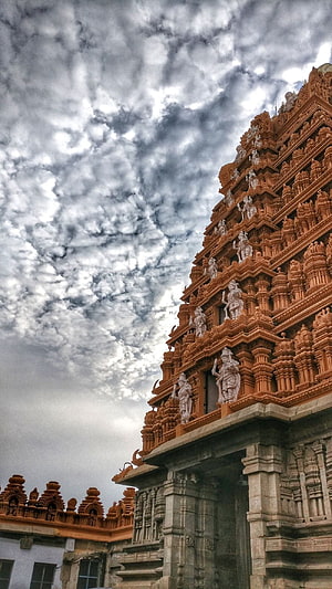 Tiruvannamalai Temple Gopuram with Intricate Carvings Under Dramatic Cloudy Sky HD phone wallpaper