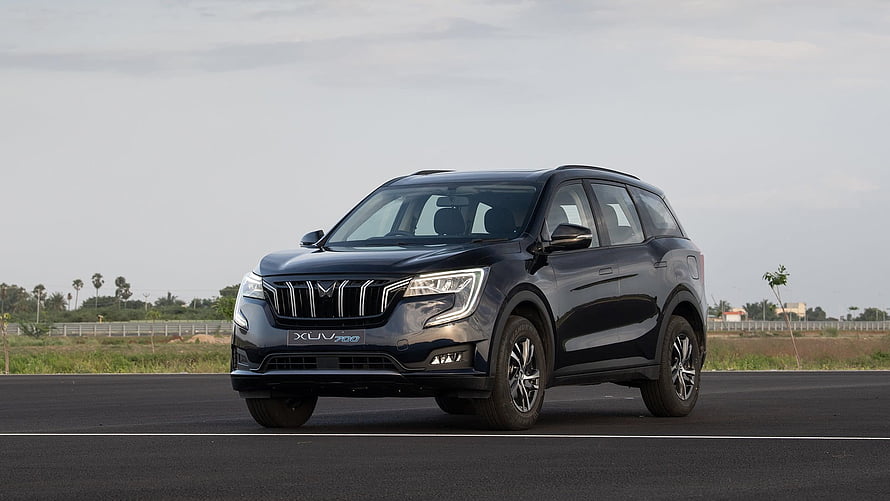 Mahindra XUV700 SUV on an open road with a sleek black exterior and modern front grille design HD wallpaper
