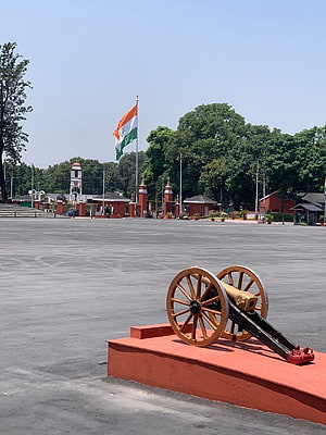 Historic cannon display at the Indian Military Academy in Dehradun with national flag HD phone wallpaper