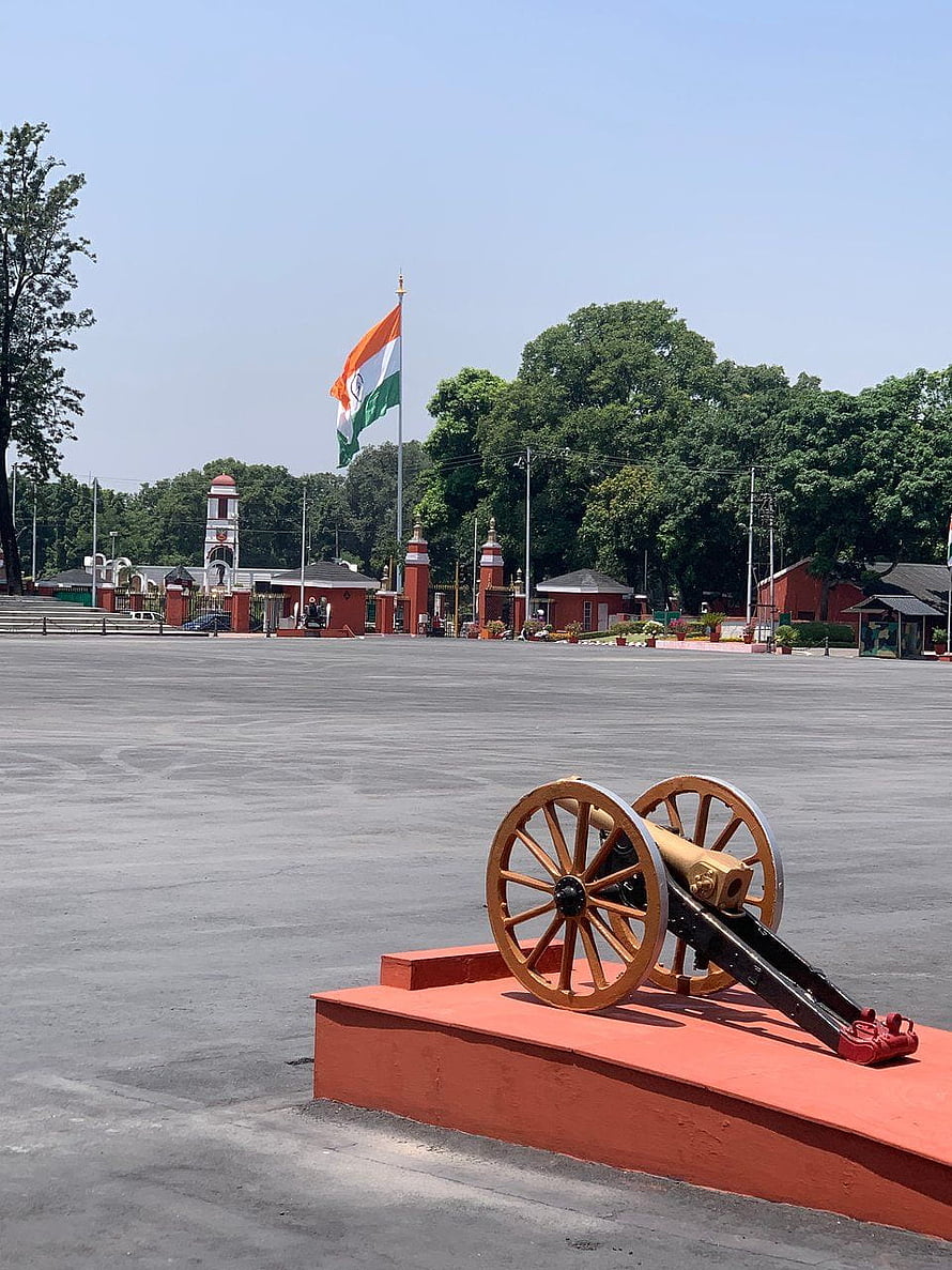 Historic cannon display at the Indian Military Academy in Dehradun with national flag HD phone wallpaper