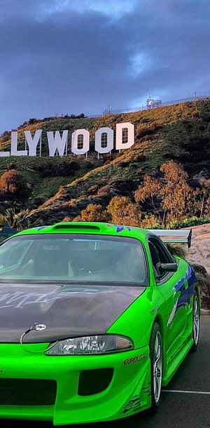 Vibrant Green Mitsubishi Eclipse Parked Before the Hollywood Sign at Dusk HD phone wallpaper