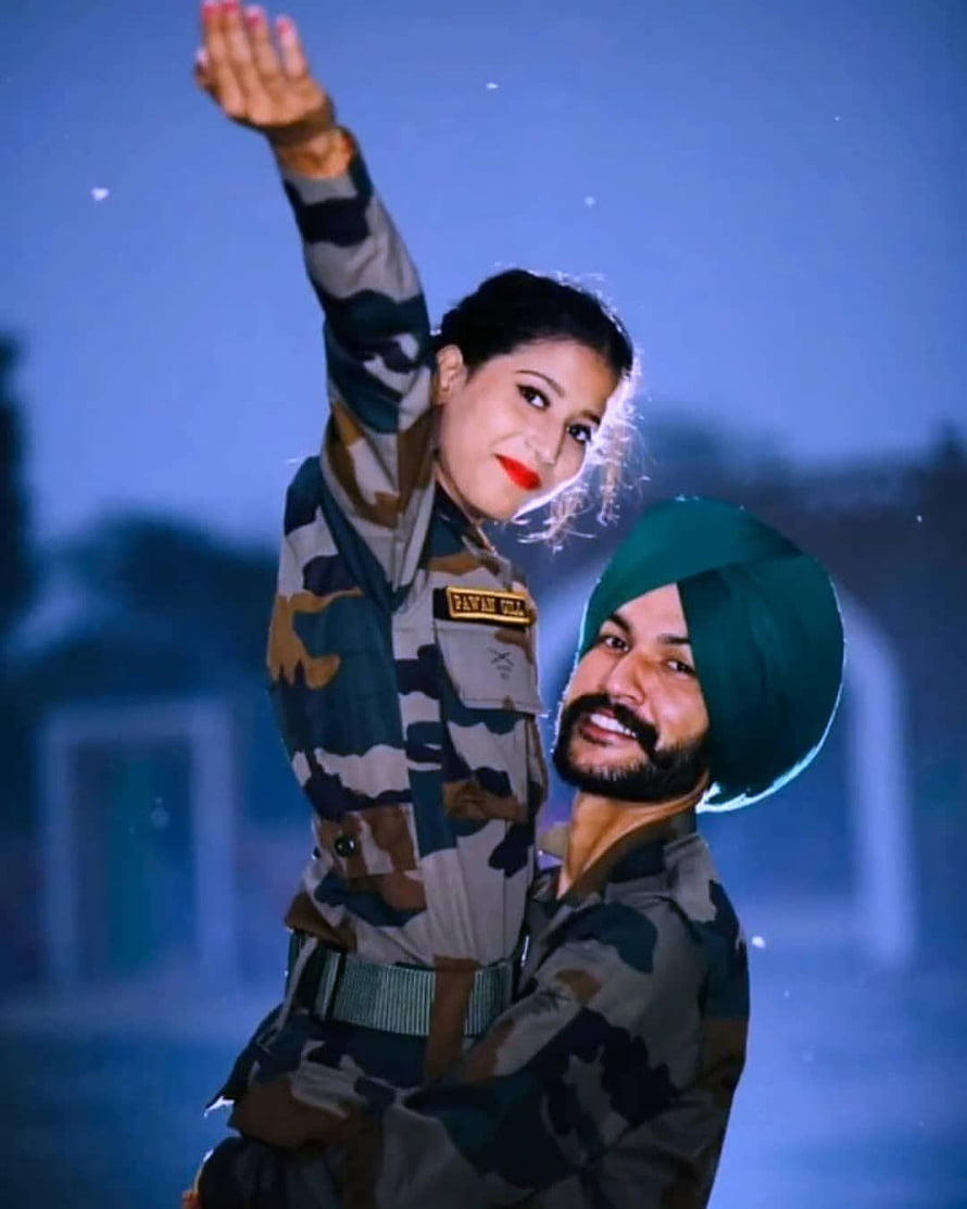Indian Army Couple in Camouflage Uniforms Sharing a Joyful Moment at Night HD phone wallpaper