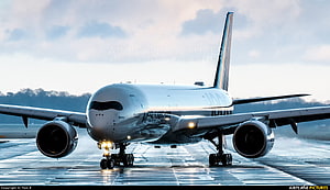 Airbus A350-1000 Wide-Body Jet Taxiing on Wet Runway at Dusk HD wallpaper