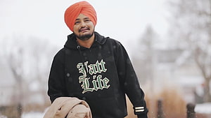 Sidhu Moose Wala in Orange Turban and Black Jatt Life Hoodie in Snowy Landscape HD wallpaper