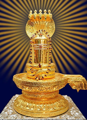 Ornate Golden Shiva Lingam with Multi-Headed Cobra Crown and Radiant Sunburst Background HD phone wallpaper