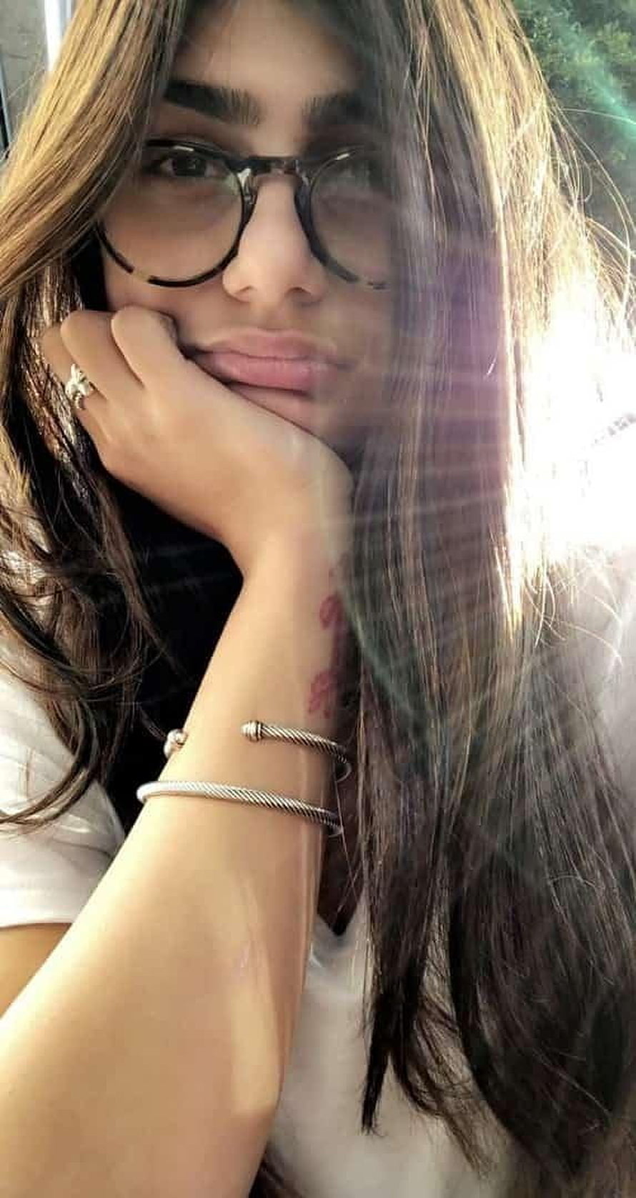 Mia Khalifa Pensive Portrait Wearing Round Glasses and Silver Bracelets HD phone wallpaper