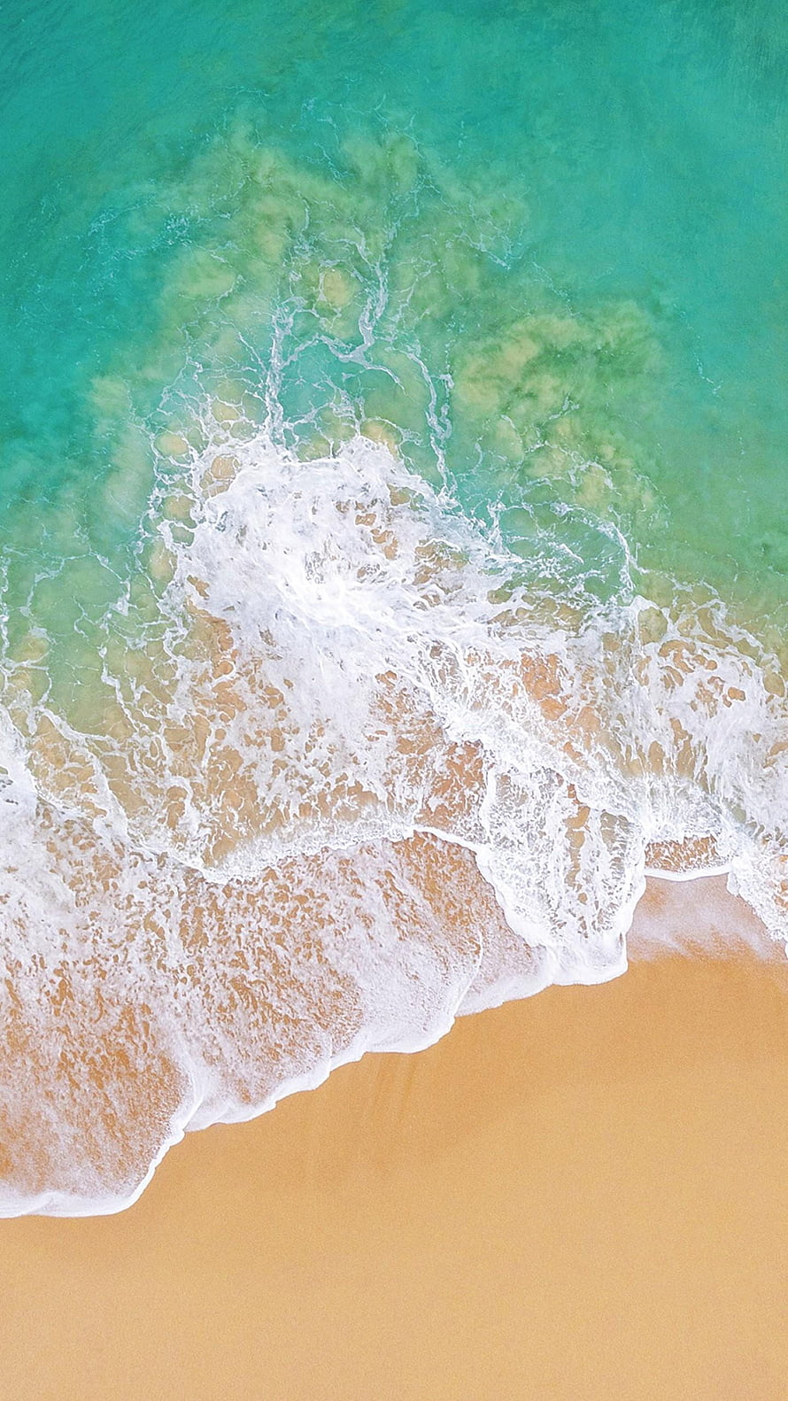 Aerial View of Turquoise Ocean Waves Washing Over Golden Sandy Beach HD phone wallpaper