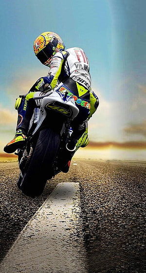 Valentino Rossi on Yamaha Racing Motorcycle Leaning into a Turn on the Track HD phone wallpaper