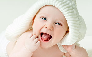 Joyful Baby Boy Laughing With White Knit Hat And Blue Eyes HD wallpaper