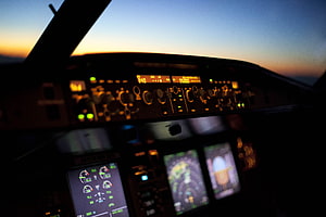 Airbus A320 Cockpit Instrument Panel at Sunset with Glowing Avionics Displays HD wallpaper
