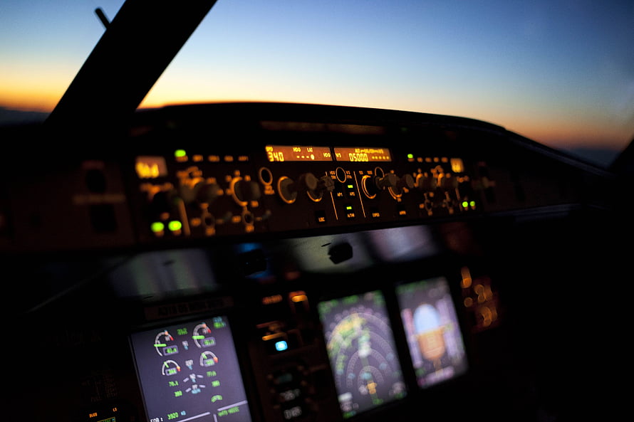 Airbus A320 Cockpit Instrument Panel at Sunset with Glowing Avionics Displays HD wallpaper