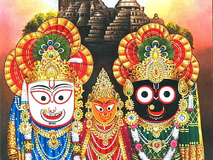 Jagannath, Balabhadra, and Subhadra deities in ornate traditional attire before a temple HD wallpaper