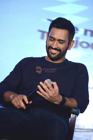 MS Dhoni Smiling While Holding a Microphone at a Public Event HD phone wallpaper