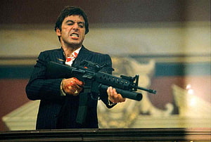 Al Pacino as Tony Montana in Scarface holding an assault rifle in a dark suit HD wallpaper
