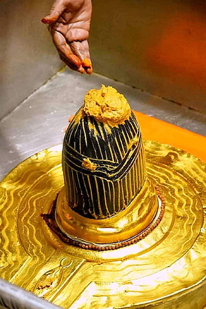 Kashi Vishwanath Temple Ritual: Hand Applying Sacred Paste to the Golden Shikhara HD phone wallpaper