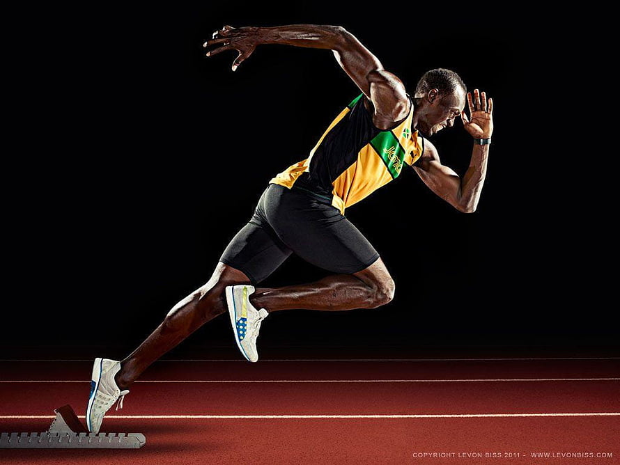Usain Bolt Sprinting in Jamaican Kit on Track HD wallpaper