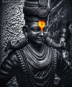 Black and White Statue of Vitthal with Glowing Orange Tilak and Traditional Ornamentation HD phone wallpaper