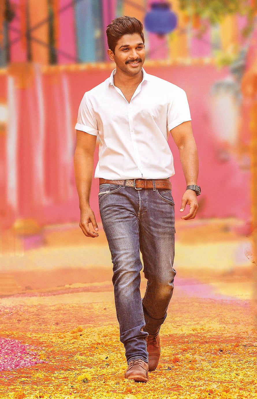 Allu Arjun in White Shirt and Jeans Walking Through Vibrant Festival Setting HD phone wallpaper