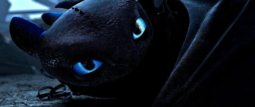 Toothless Night Fury Close-Up with Glowing Blue Eyes in Dark Cinematic Setting HD wallpaper